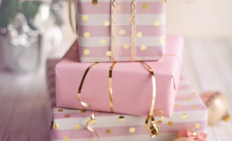 Elegantly wrapped Christmas gifts with ribbons and festive decoration, styled for gift-giving inspiration